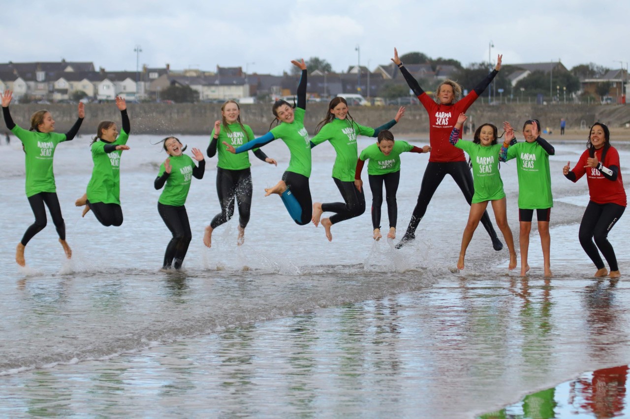 a group of people splashing in the sea